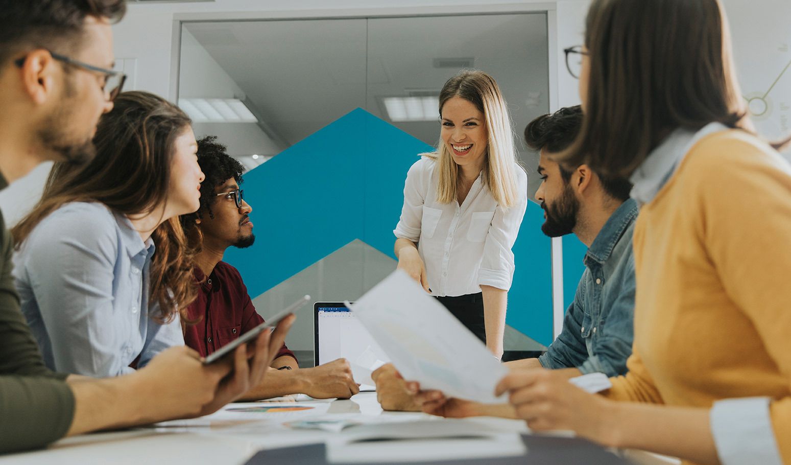fairfamily-offboarding-prozessoptimierung Ein Team sitzt zusammen an einem Schreibtisch,